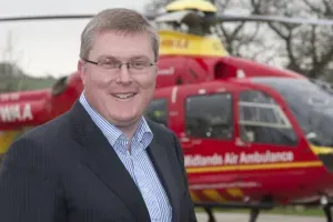 Maac Man In A Suit Standing In Front Of A Helicopter