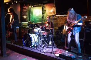 Maac Musicians Playing Music On Stage In A Dark Room With A Band