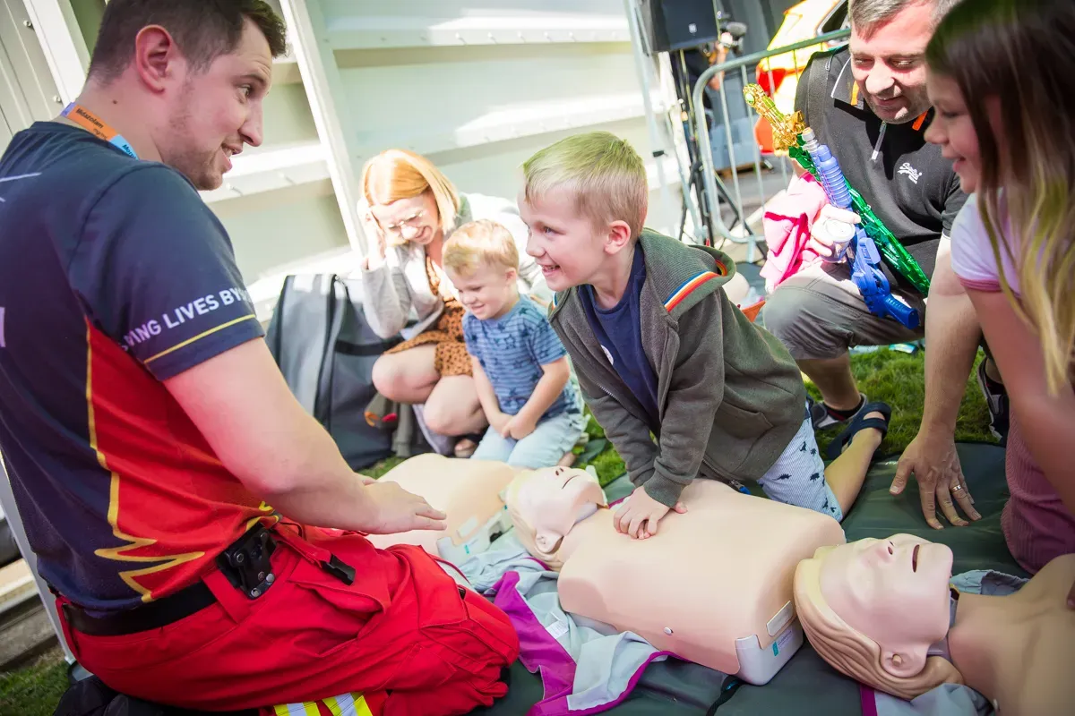 Maac People Are Gathered Around A Dummy With A Dummy On It