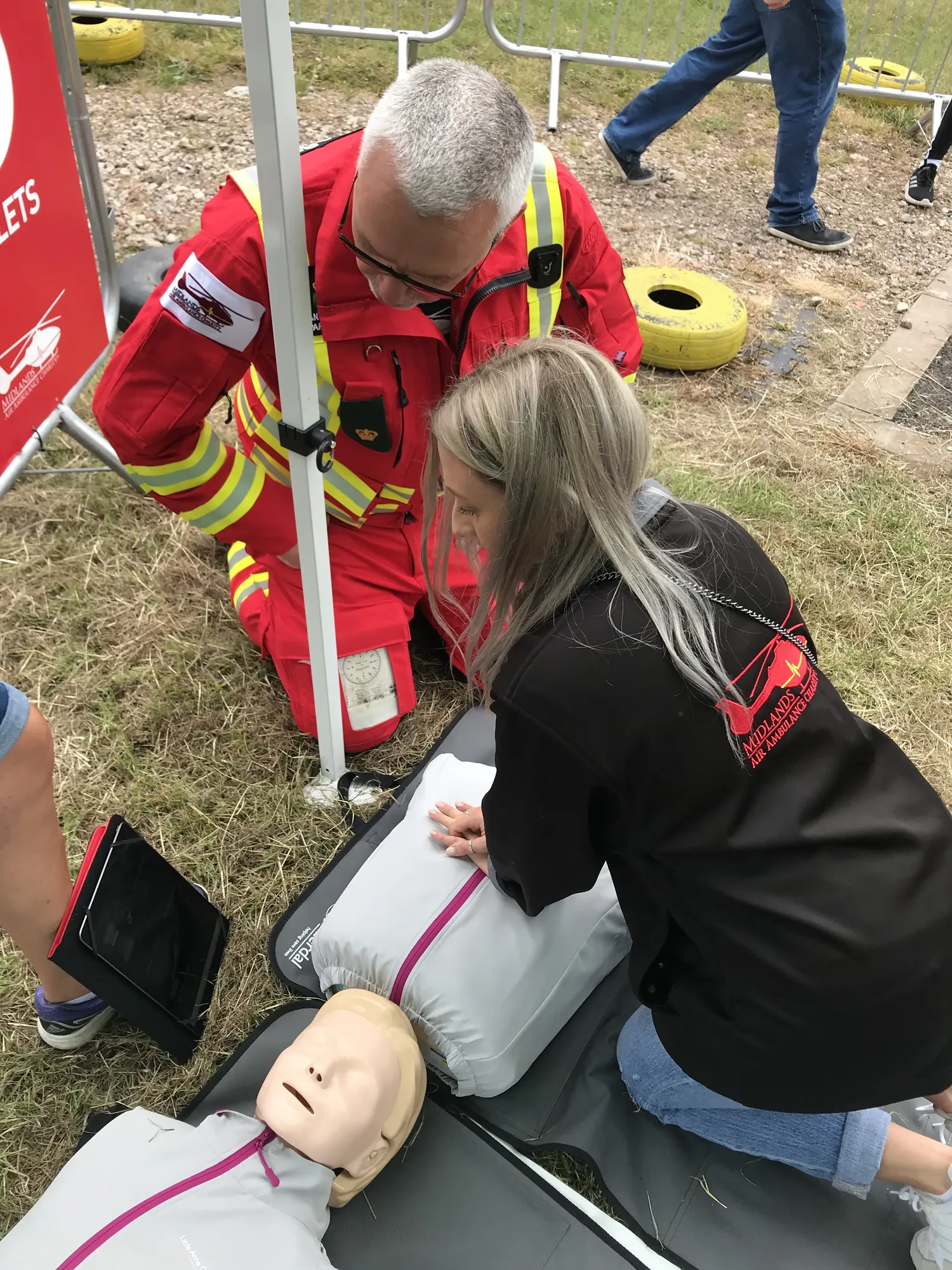 Maac People Are Gathered Around A Dummy With A Fireman On It