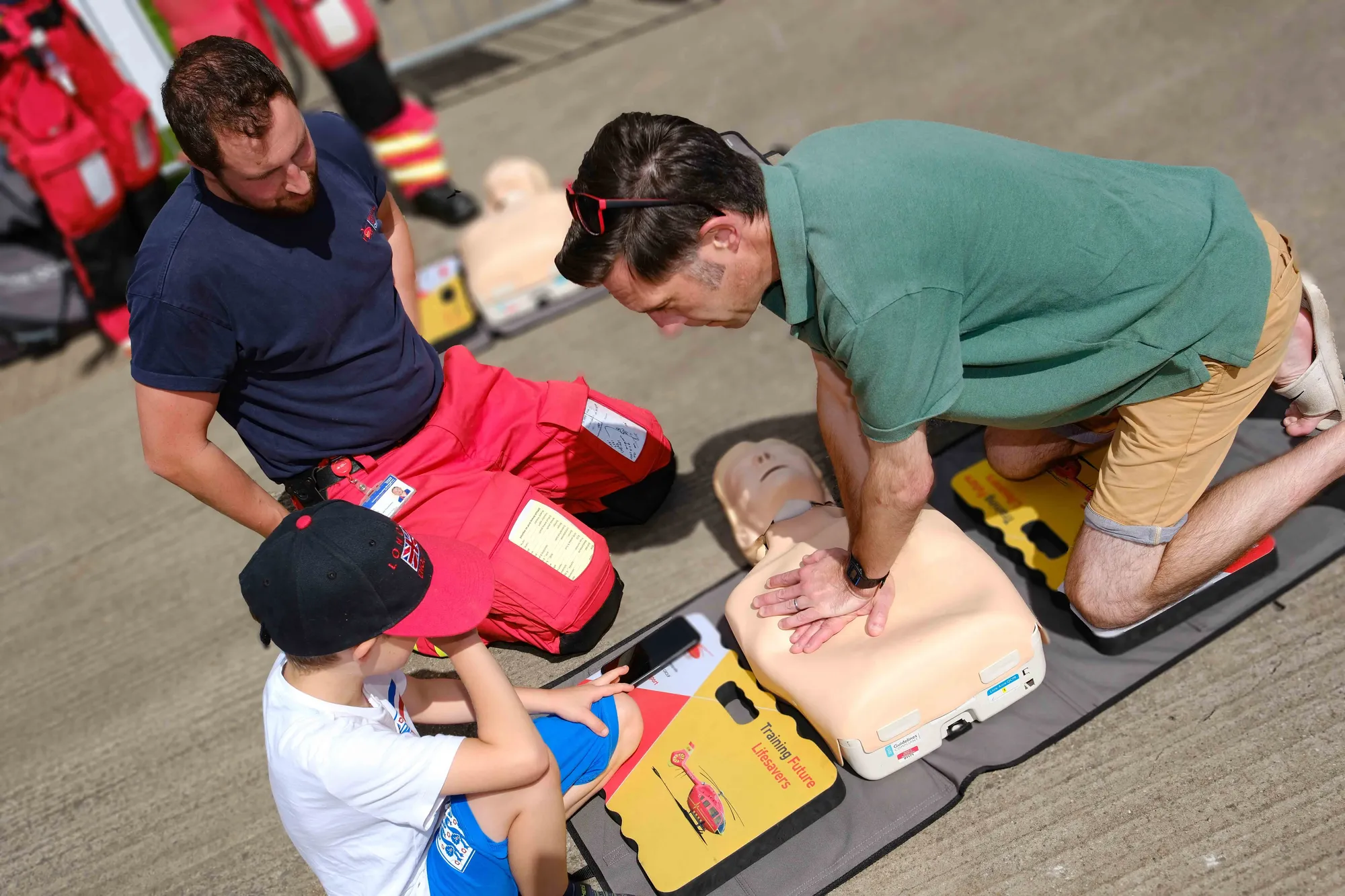 Maac People Are Helping A Child With A Dummy On A Stretcher