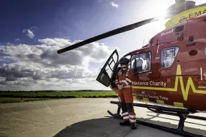 Maac Rescue Helicopter With A Man Standing Next To It