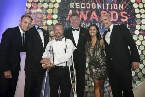 Maac Several People In Suits And Ties Standing On A Stage With Crutches