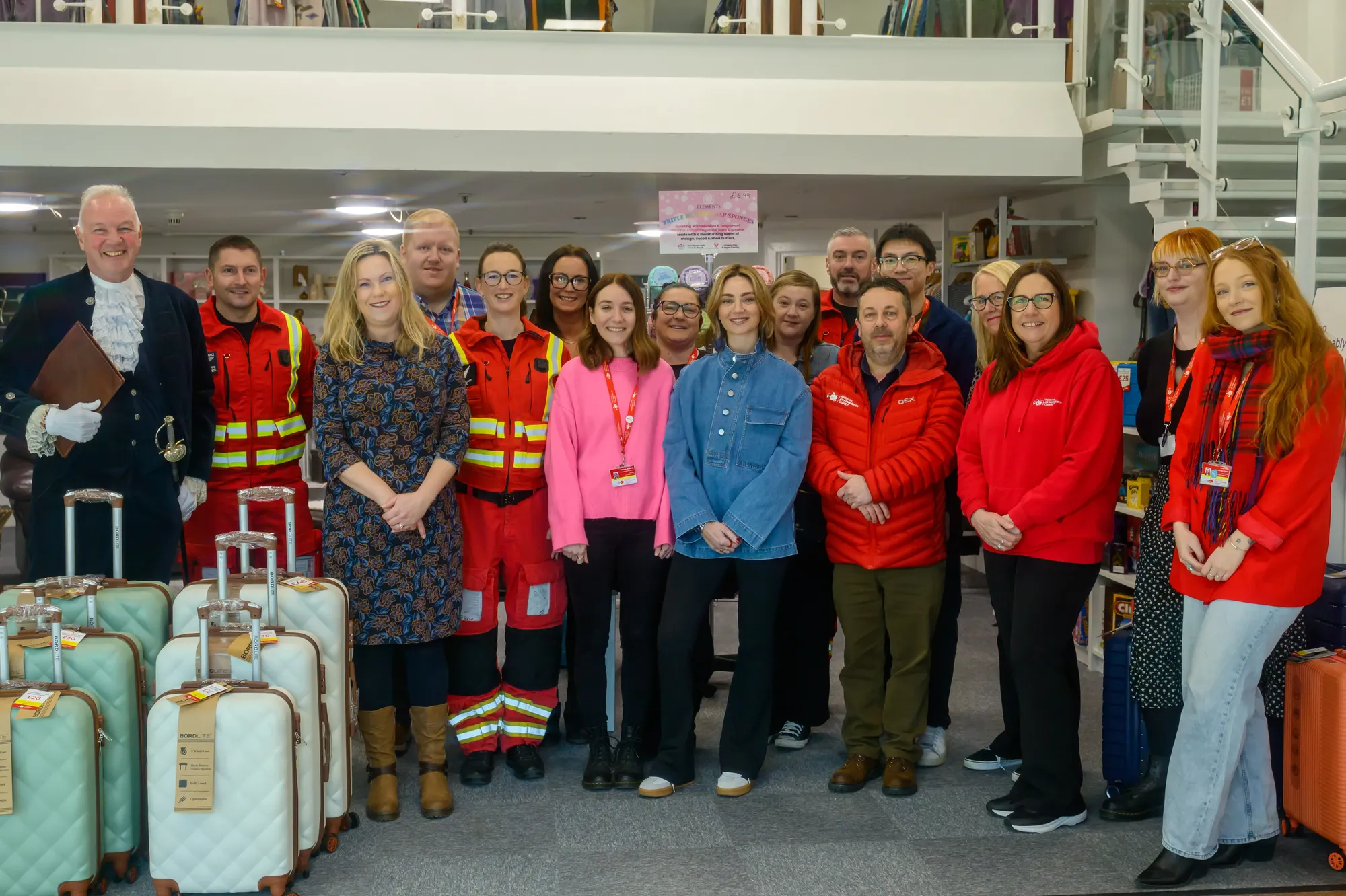 Maac Several People Standing In A Room With Luggage And A Staircase