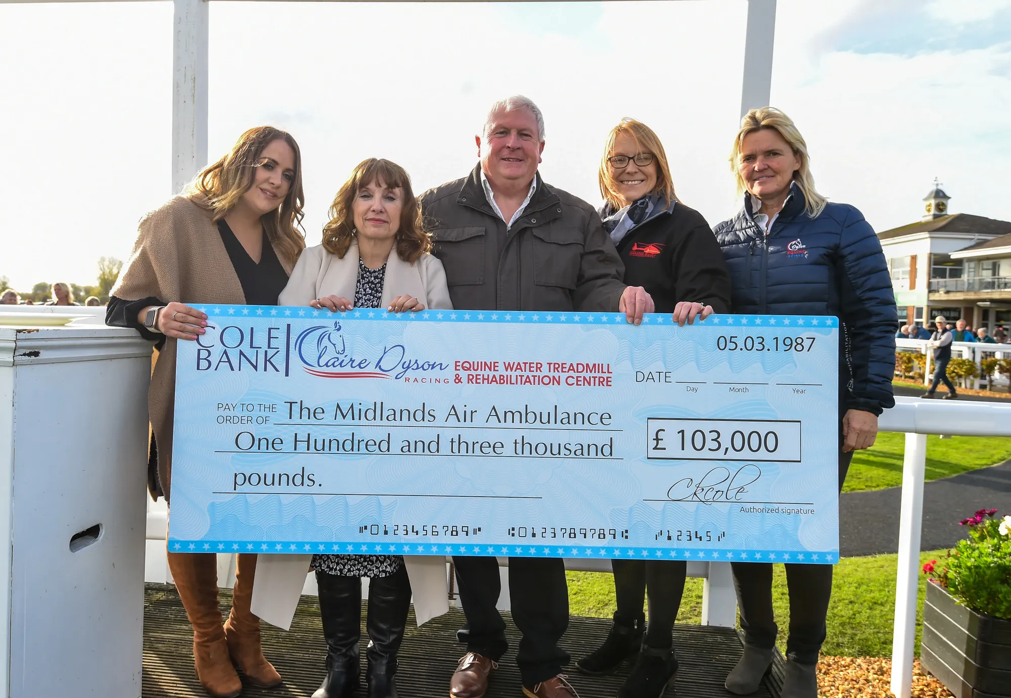 Maac Several People Standing Next To A Giant Check For A Horse Race