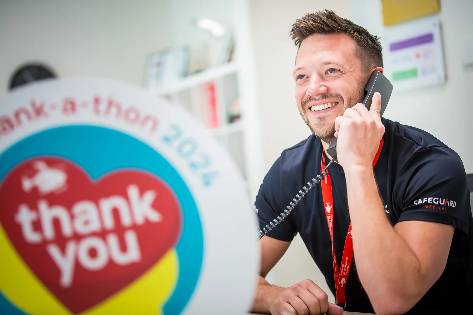 Maac Smiling Man On The Phone In Front Of A Thank You Sign