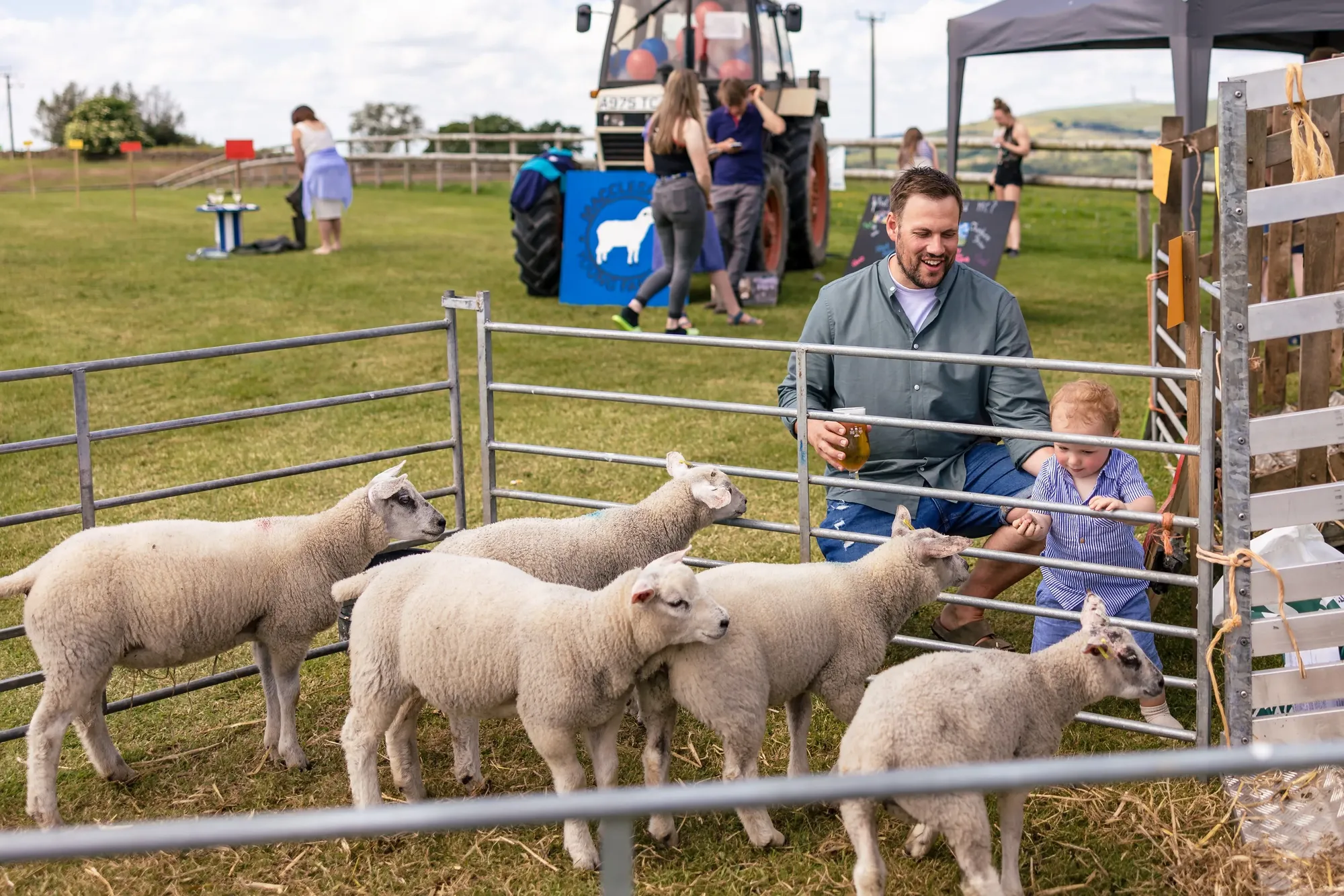 Maac There Are A Lot Of Sheep In A Pen With A Man And A Child