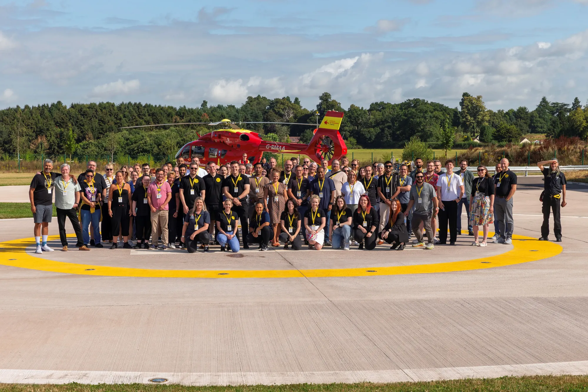 Maac There Are Many People Standing In Front Of A Helicopter On The Tarmac