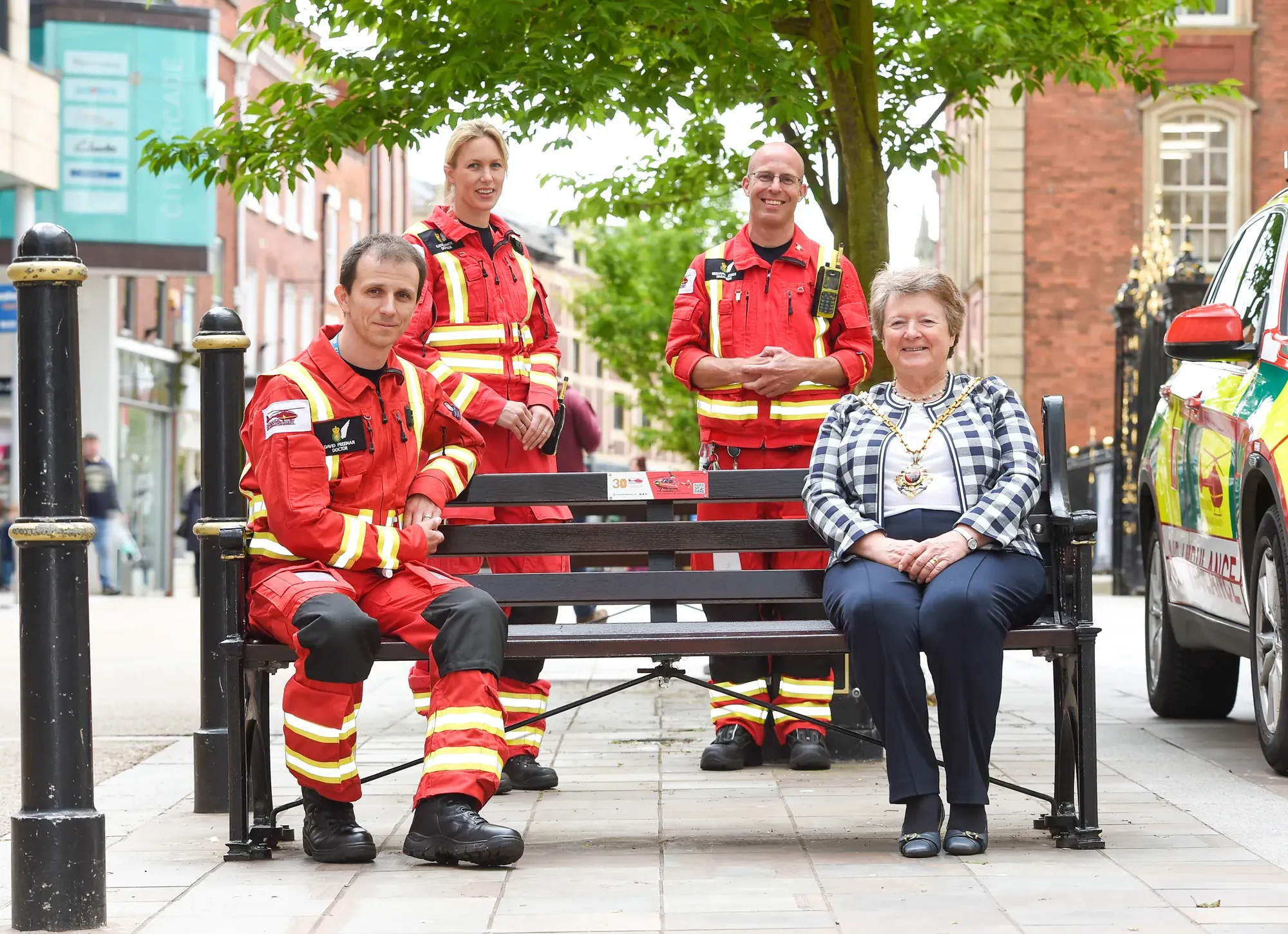 Maac There Are Three Firemen Sitting On A Bench With A Woman