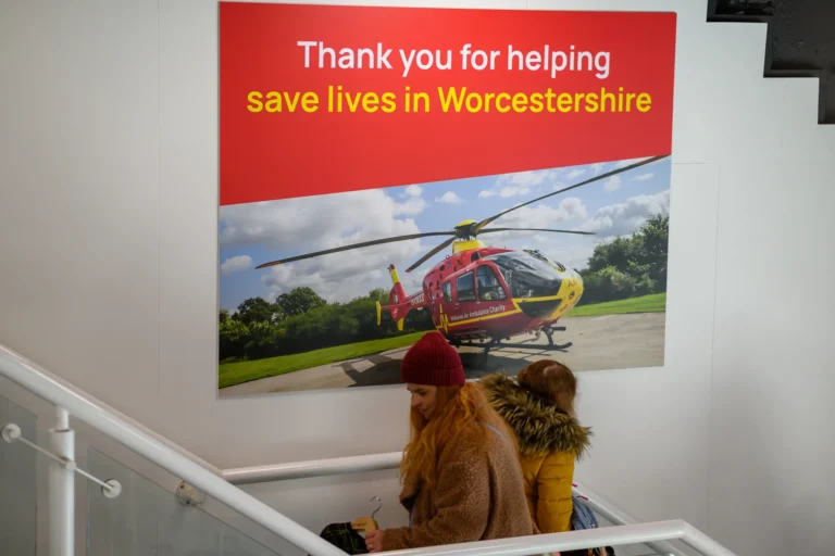 Maac There Are Two People Standing On The Stairs Looking At A Helicopter