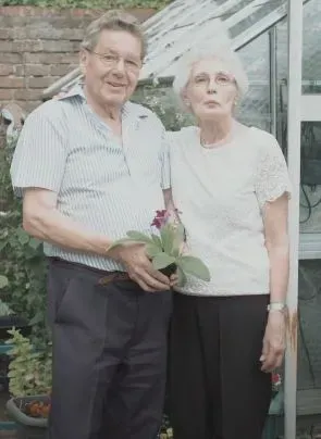 Maac There Is A Man And Woman Standing In Front Of A Greenhouse