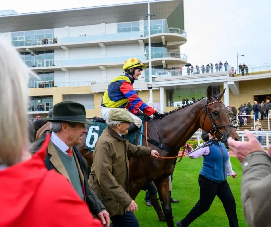 Maac There Is A Man Riding A Horse In A Race With A Crowd