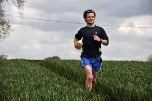 Maac There Is A Man Running In A Field With A Frisbee