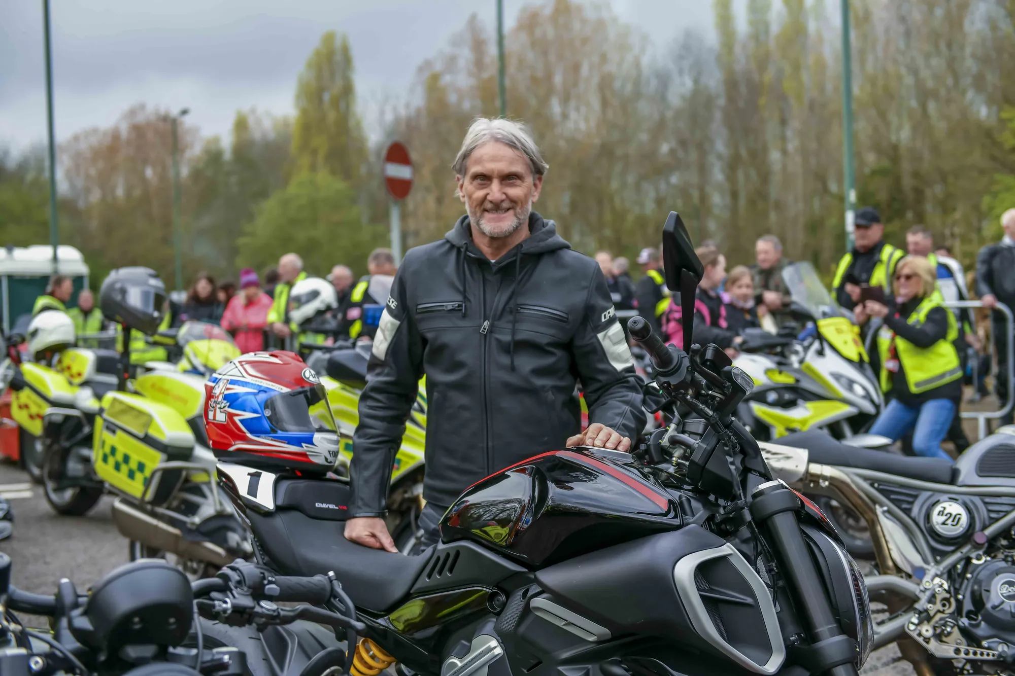 Maac There Is A Man Standing Next To A Group Of Motorcycles