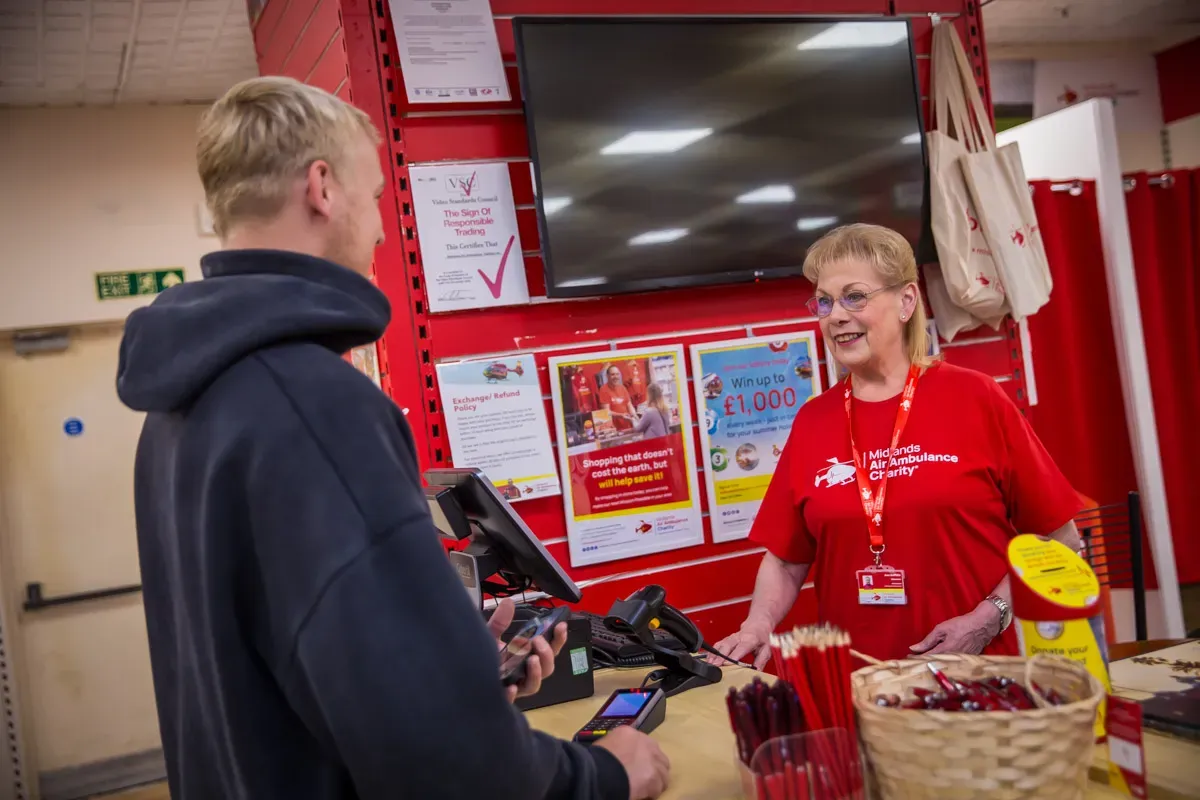 Maac There Is A Woman Standing At A Counter With A Man Behind Her
