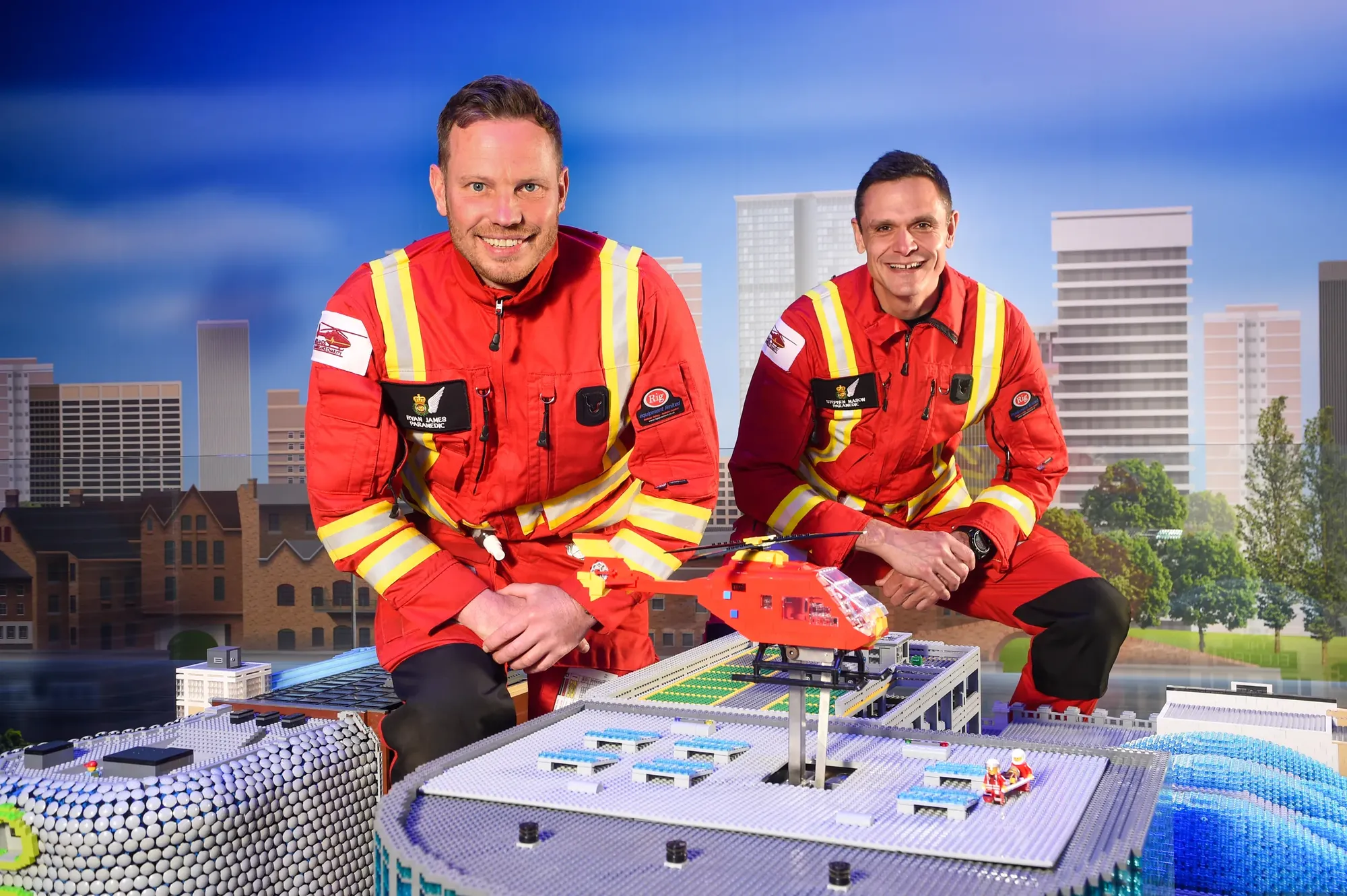 Maac They Are Two Men In Red Uniforms Sitting On A Table