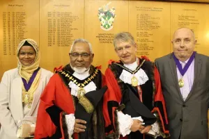 Maac Three Men And Two Women In Robes Standing Next To A Wall