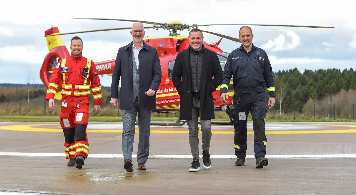 Maac Three Men In Suits And Ties Walking Towards A Helicopter