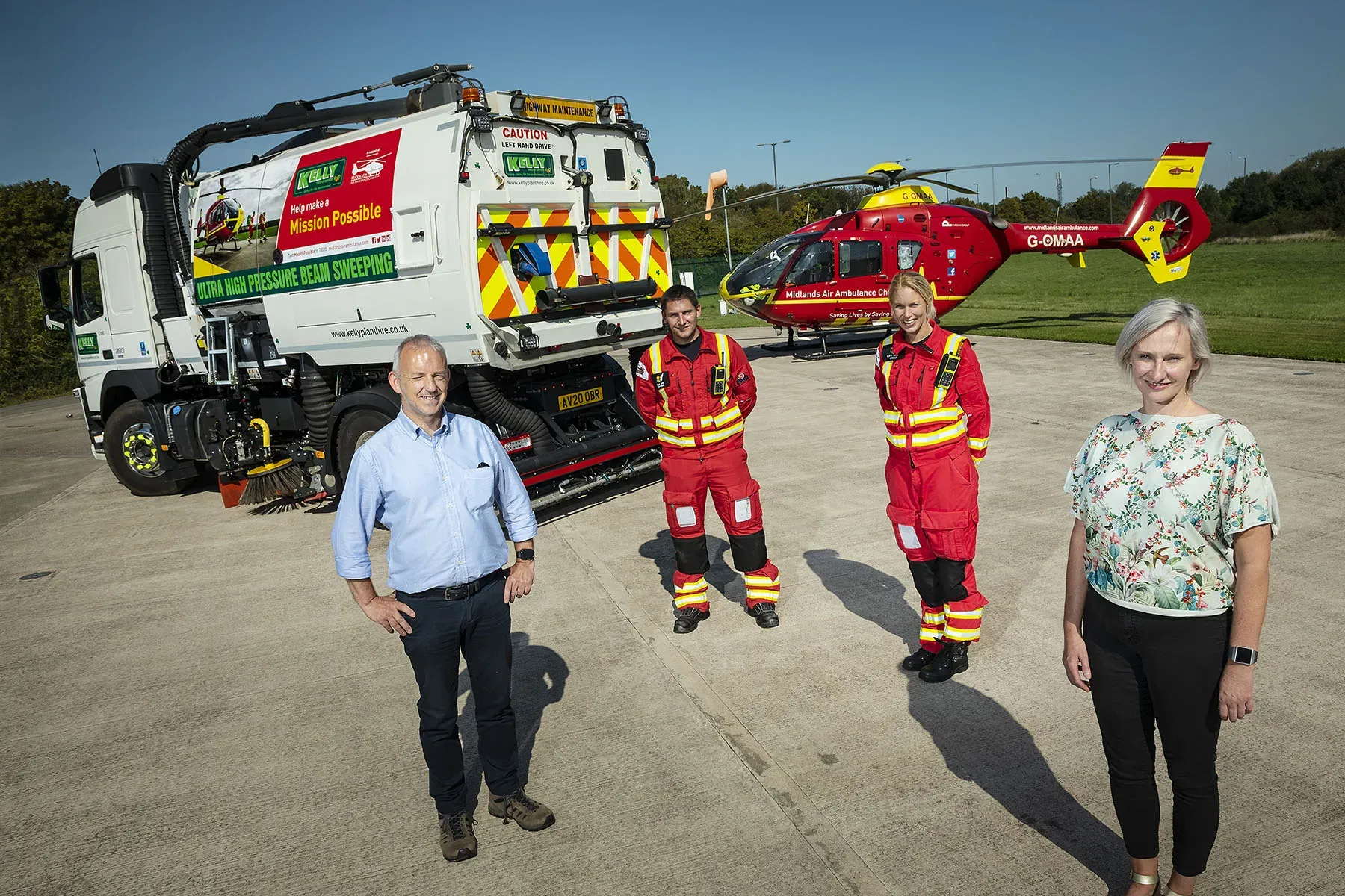 Maac Three People Standing In Front Of A Fire Truck And A Helicopter