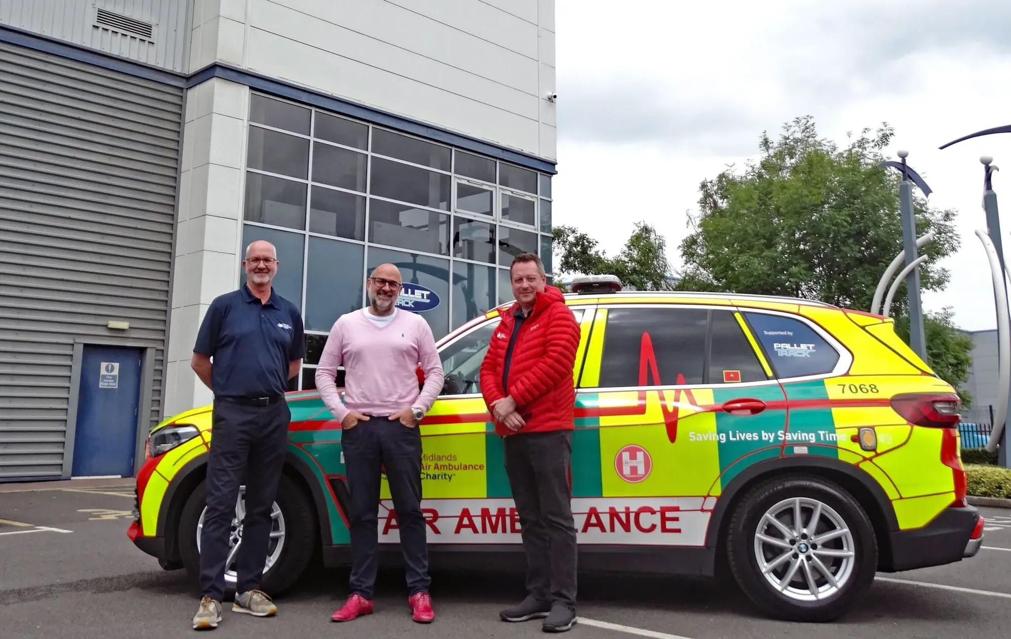 Maac Three People Standing Next To A Car With A Paramedic On It