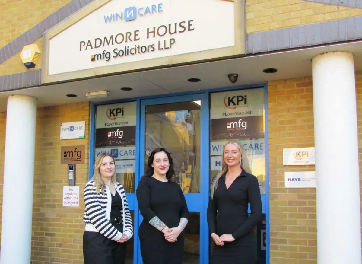 Maac Three Women Standing Outside Of A Building With A Sign Above Them