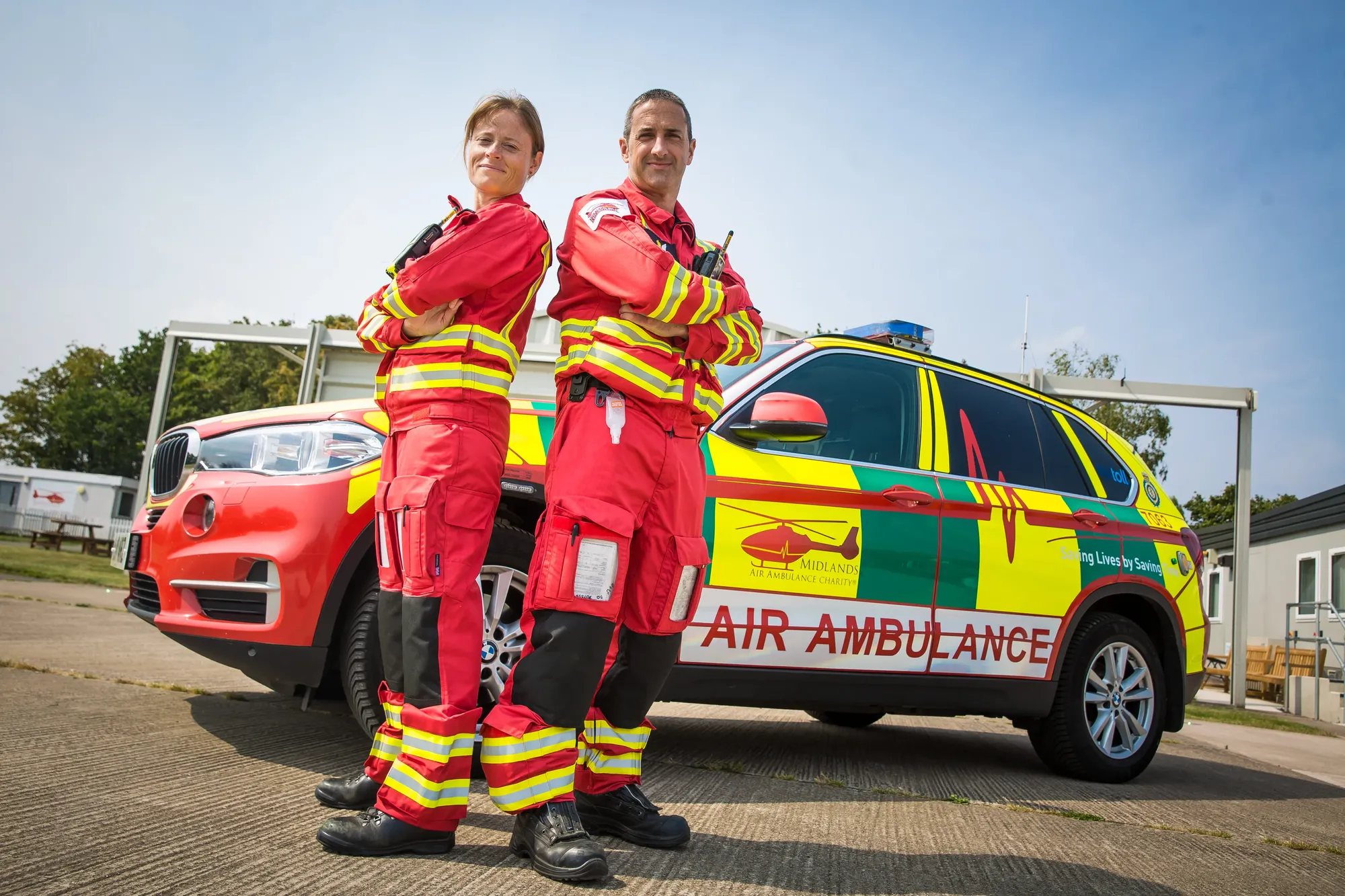 Maac Two Women In Fire Uniforms Standing Next To A Car