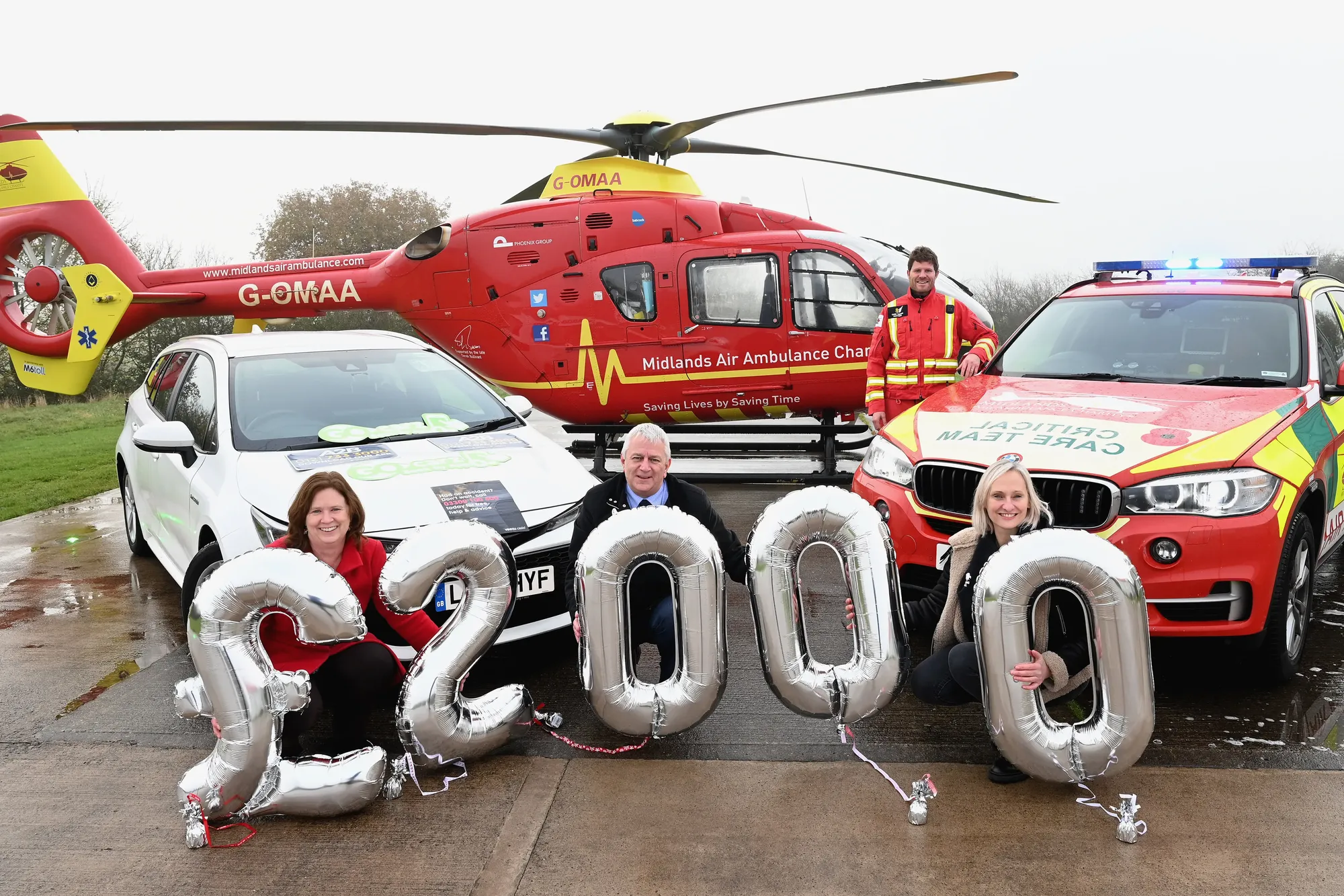 Maac Vehicle And A Helicopter With Balloons In The Shape Of Numbers