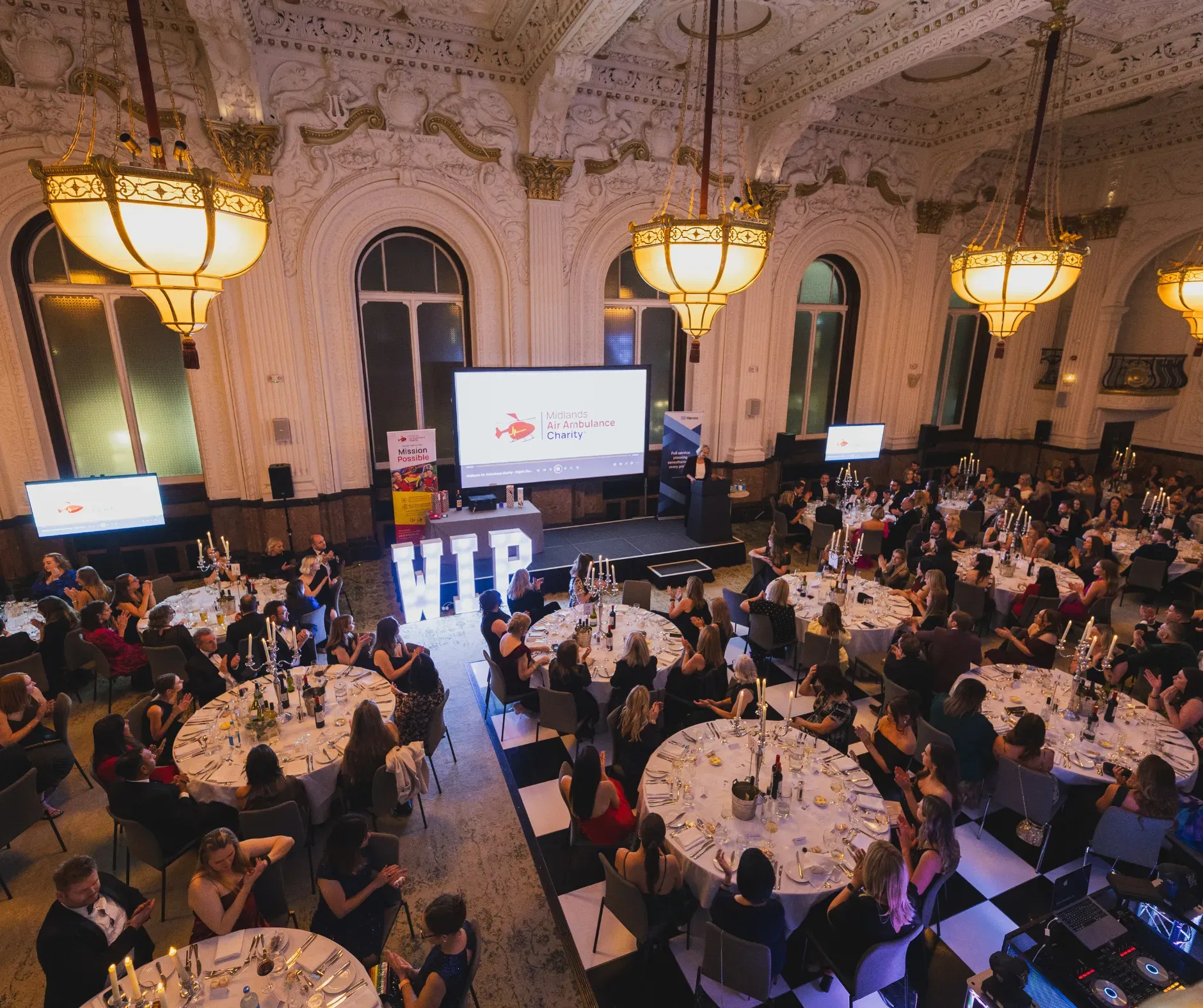 Maac View Of A Large Room With Tables And Chairs And A Stage