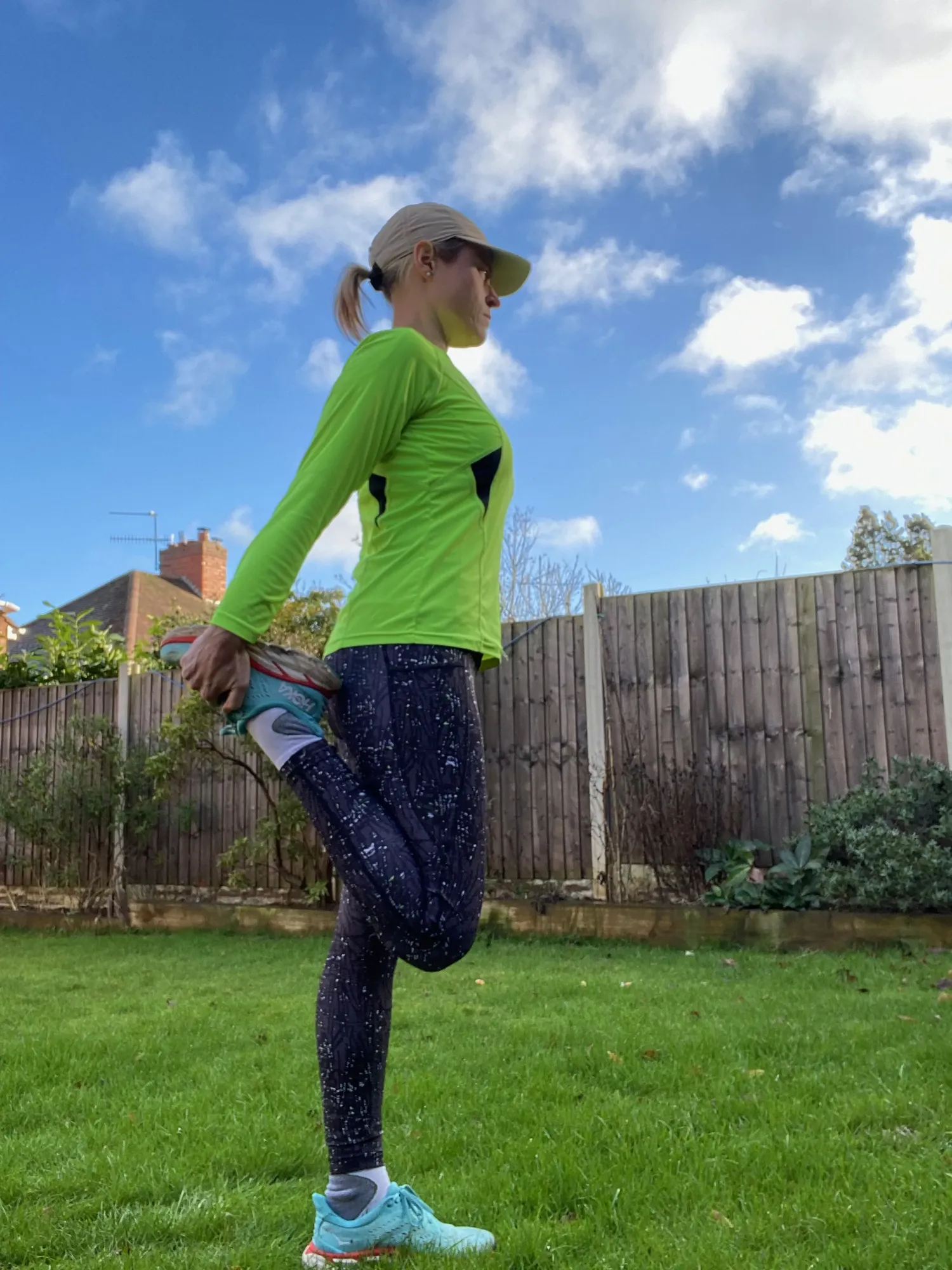 Maac Woman In A Green Shirt And Blue Leggings Is Standing On A Skateboard