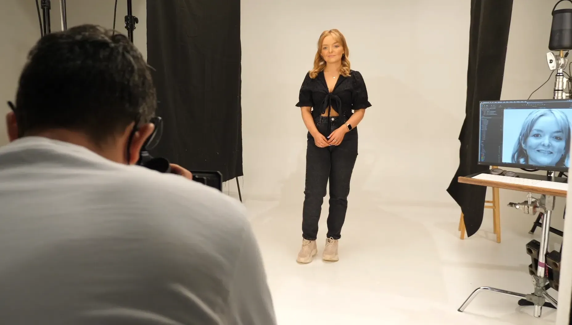 Maac Woman Standing In Front Of A Camera In A Studio