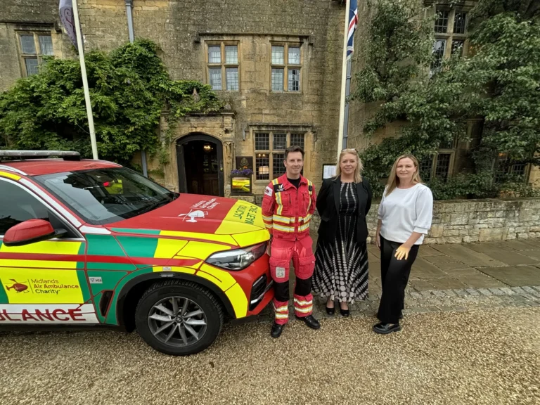 Maac Woman Standing Next To A Car With A Fireman Standing Beside Her