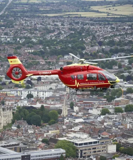 Maac Gloucestershire Helicopter Flying Over A City With A Church In The Background 1024x653 Copy