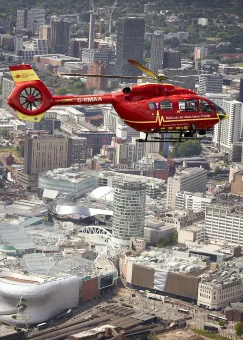 Maac West Midlands Helicopter Flying Over A City With A Large Building In The Background 1024x683 Copy