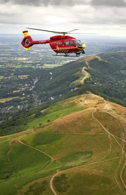 Maac Worcesteshire Helicopter Flying Over A Green Mountain With A Valley Below 1024x683 Copy
