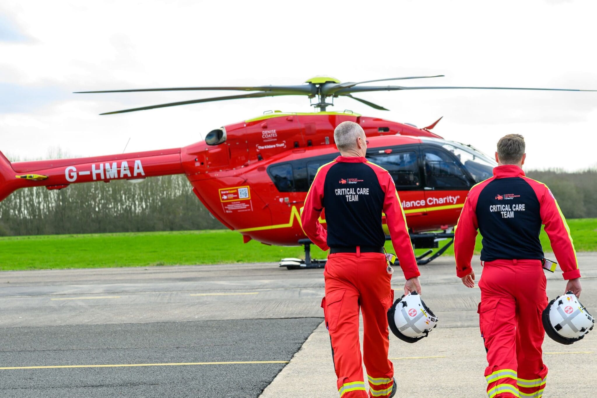 critical care team walking towards midlands air ambulance charity helicopter