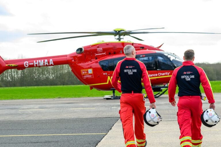 critical care team walking towards midlands air ambulance charity helicopter